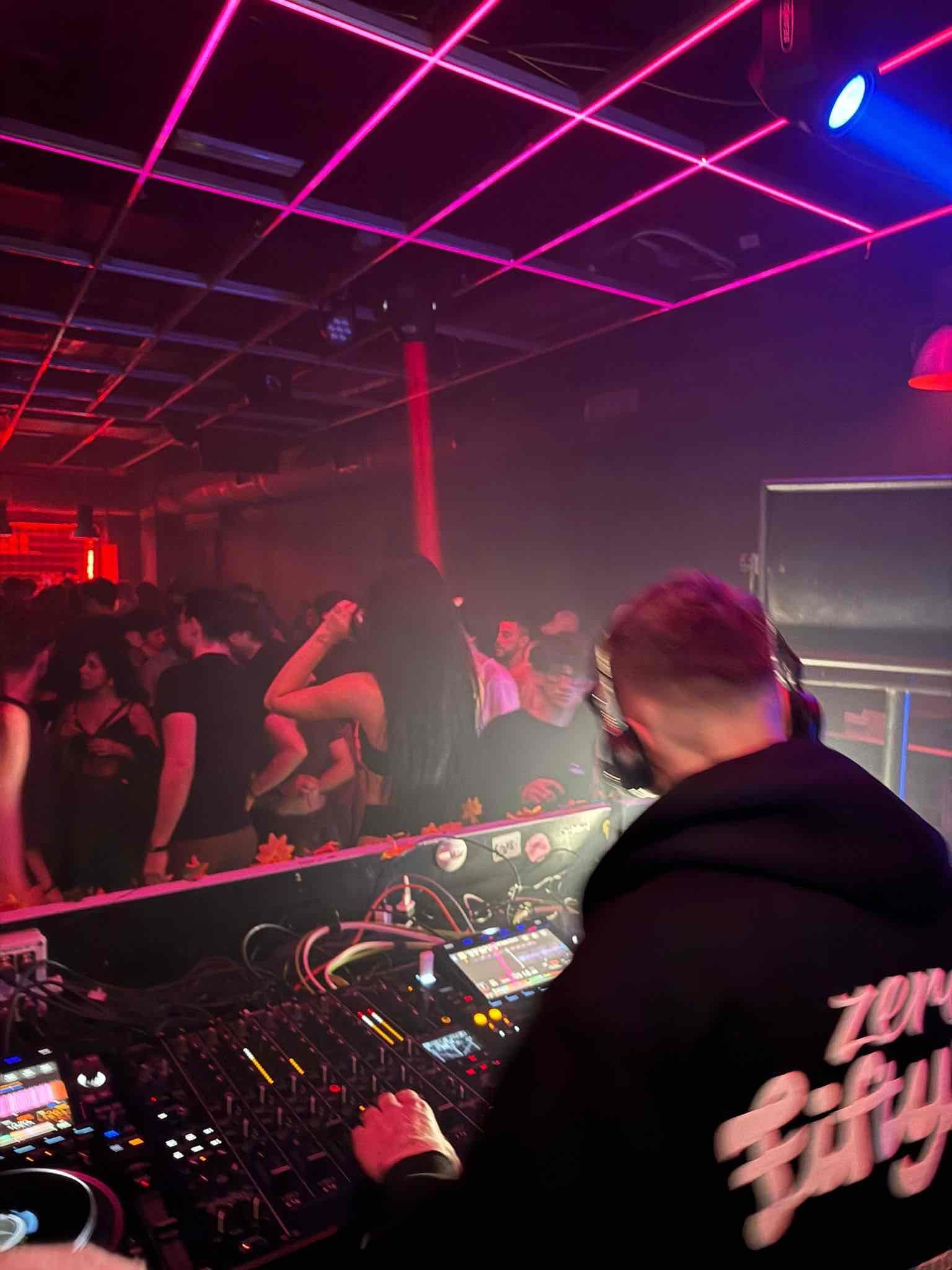 Neon grid ceiling at a VERHAAL progressive house club event in Milan, Italy