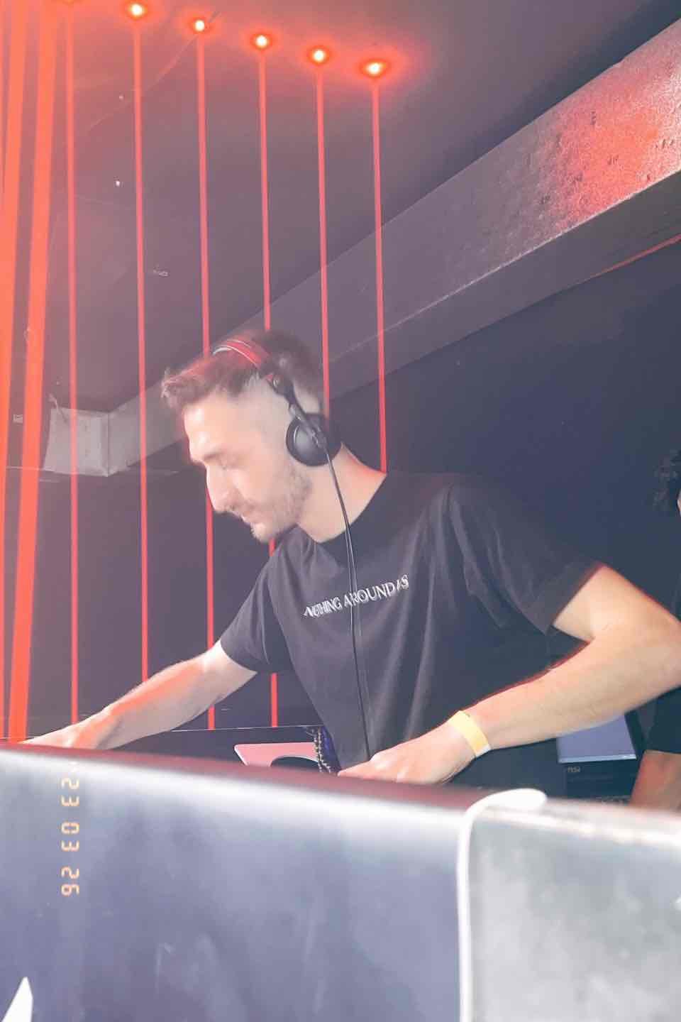 VERHAAL DJ under red laser lights during a progressive house set in Milan, Italy