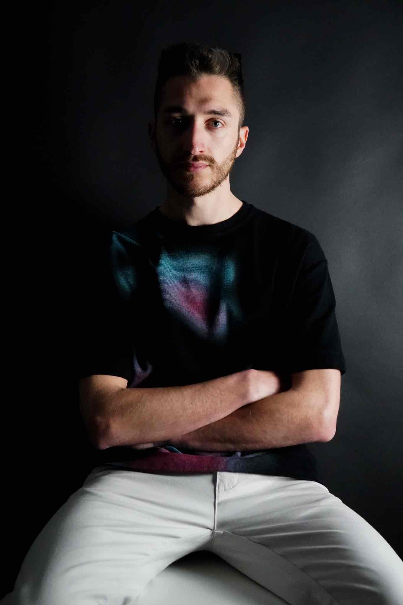 Seated portrait of VERHAAL, progressive house DJ in Switzerland
